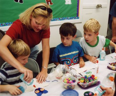Children are hard at work making their puppets